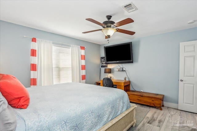 6961 Elliots Gin Ln, Navarre, FL 32566 - bedroom with wood finished floors, a ceiling fan, and baseboards
