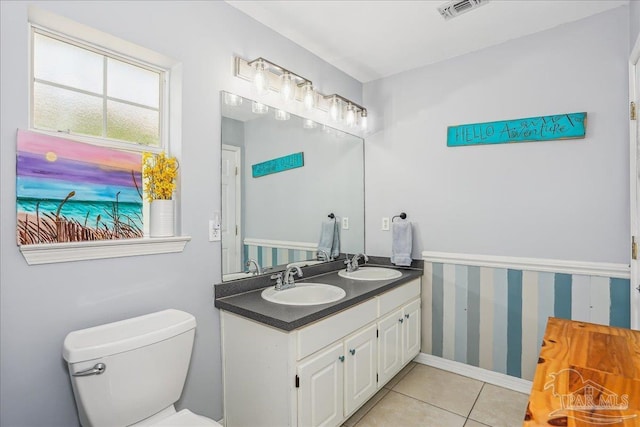6961 Elliots Gin Ln, Navarre, FL 32566 - full bath with double vanity, toilet, wallpapered walls, and tile patterned floors