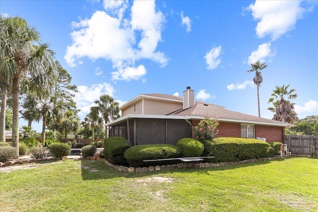 6961 Elliots Gin Ln, Navarre, FL 32566 - view of side of property featuring a sunroom and a chimney