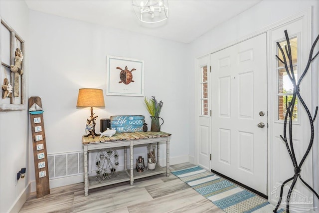 6961 Elliots Gin Ln, Navarre, FL 32566 - entryway with wood finished floors and baseboards