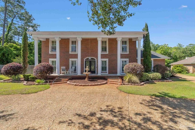 2960 Laurel Dr, Gulf Breeze, FL 32563 - greek revival house featuring a porch, brick siding, and a front lawn
