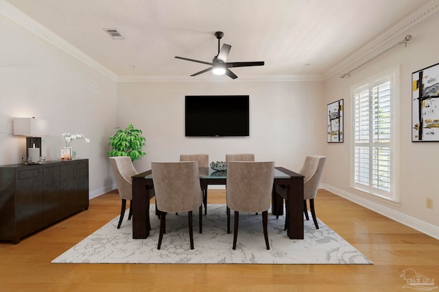 2960 Laurel Dr, Gulf Breeze, FL 32563 - dining room with light wood-style floors, ceiling fan, baseboards, and ornamental molding