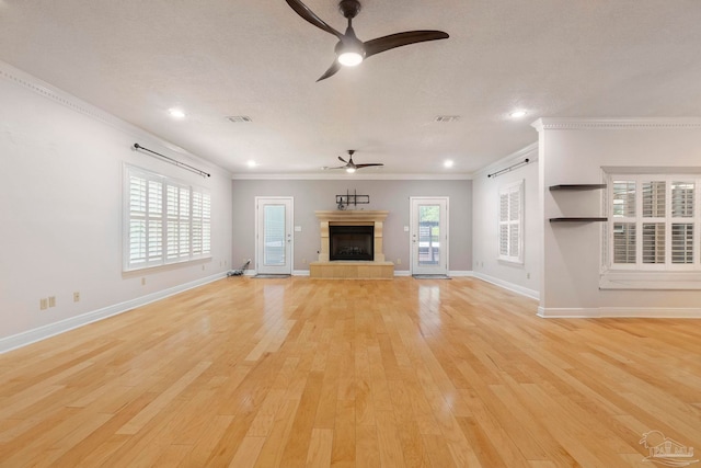 2960 Laurel Dr, Gulf Breeze, FL 32563 - unfurnished living room with a ceiling fan, light wood-style flooring, crown molding, a tiled fireplace, and baseboards