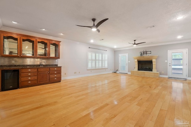 2960 Laurel Dr, Gulf Breeze, FL 32563 - unfurnished living room featuring ceiling fan, light wood-style flooring, plenty of natural light, ornamental molding, and recessed lighting