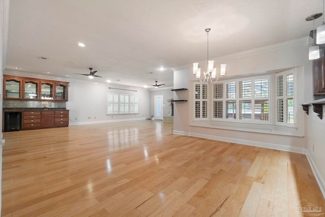 2960 Laurel Dr, Gulf Breeze, FL 32563 - unfurnished living room featuring ceiling fan, a chandelier, baseboards, beverage cooler, and recessed lighting