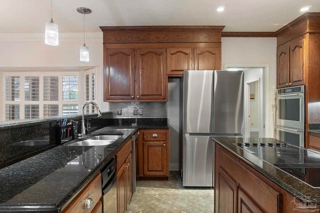 2960 Laurel Dr, Gulf Breeze, FL 32563 - kitchen with stainless steel appliances, a sink, crown molding, decorative light fixtures, and brown cabinets
