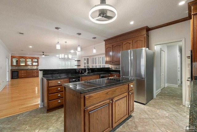 2960 Laurel Dr, Gulf Breeze, FL 32563 - kitchen with freestanding refrigerator, a peninsula, ornamental molding, a kitchen island, and black electric stovetop