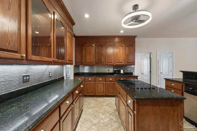 2960 Laurel Dr, Gulf Breeze, FL 32563 - kitchen featuring black electric stovetop, brown cabinets, backsplash, ornamental molding, and dark stone countertops