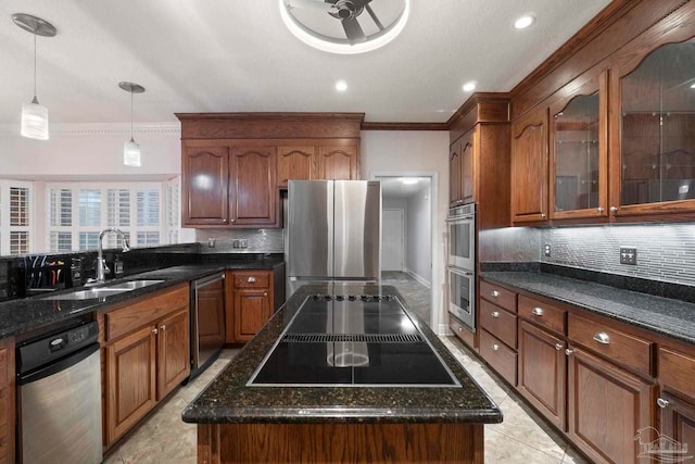 2960 Laurel Dr, Gulf Breeze, FL 32563 - kitchen with stainless steel appliances, a sink, ornamental molding, tasteful backsplash, and dark stone counters