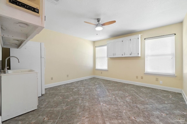 2960 Laurel Dr, Gulf Breeze, FL 32563 - unfurnished room featuring ceiling fan, baseboards, and a sink
