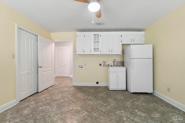 2960 Laurel Dr, Gulf Breeze, FL 32563 - kitchen featuring freestanding refrigerator, baseboards, white cabinetry, ceiling fan, and a sink
