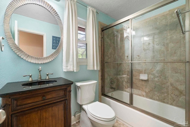 2960 Laurel Dr, Gulf Breeze, FL 32563 - full bathroom with toilet, shower / bath combination with glass door, vanity, a textured ceiling, and baseboards