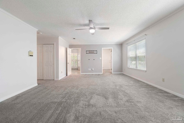 2960 Laurel Dr, Gulf Breeze, FL 32563 - unfurnished living room featuring crown molding, ceiling fan, carpet, a textured ceiling, and baseboards