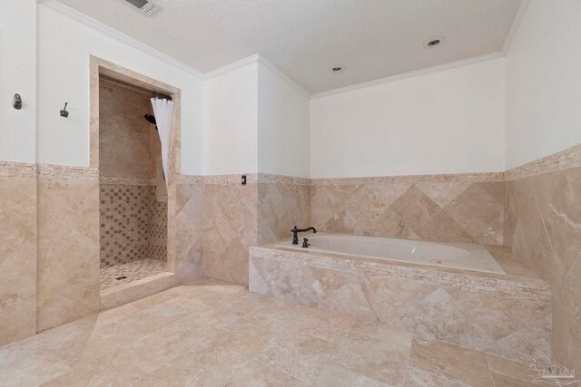 2960 Laurel Dr, Gulf Breeze, FL 32563 - bathroom with tile walls, a bath, a tile shower, crown molding, and a wainscoted wall