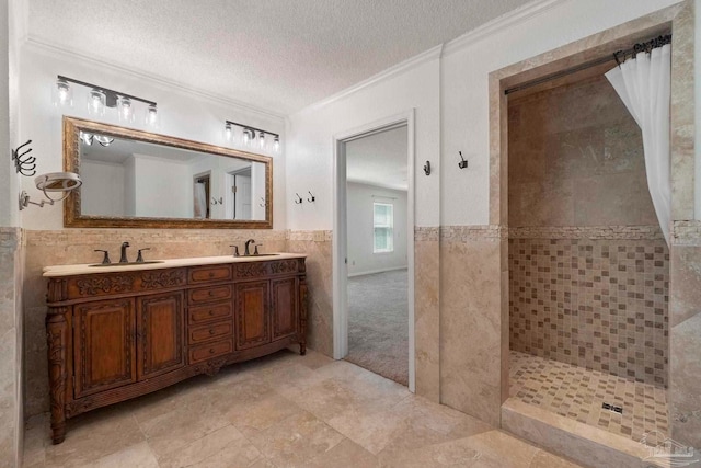 2960 Laurel Dr, Gulf Breeze, FL 32563 - full bath with ornamental molding, tile walls, a textured ceiling, a tile shower, and double vanity
