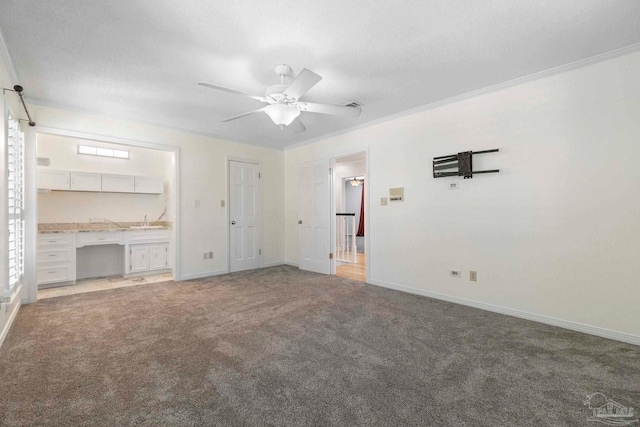 2960 Laurel Dr, Gulf Breeze, FL 32563 - unfurnished living room with light colored carpet, a ceiling fan, baseboards, ornamental molding, and a sink