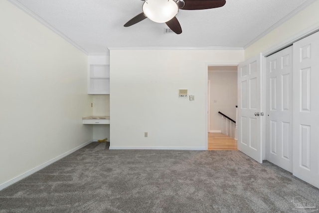 2960 Laurel Dr, Gulf Breeze, FL 32563 - unfurnished bedroom with carpet floors, ornamental molding, a textured ceiling, a closet, and baseboards