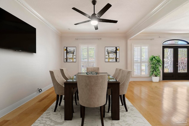 2960 Laurel Dr, Gulf Breeze, FL 32563 - dining area featuring light wood-type flooring, baseboards, ceiling fan, and crown molding