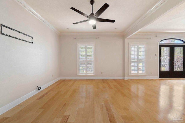 2960 Laurel Dr, Gulf Breeze, FL 32563 - spare room with a textured ceiling, light wood-style flooring, baseboards, ornamental molding, and a ceiling fan