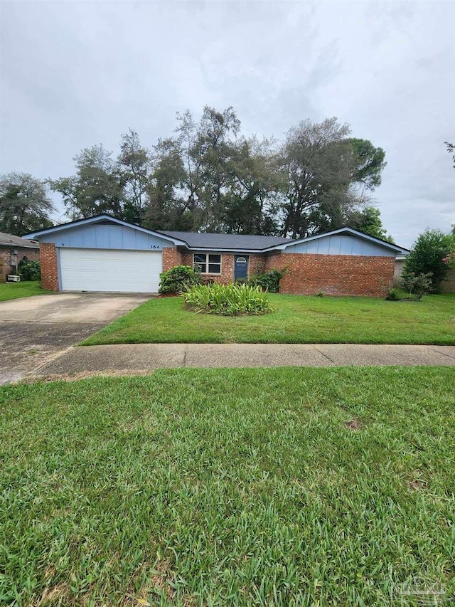 ranch-style home featuring a front lawn and a garage