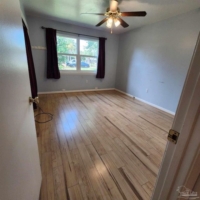 empty room featuring light hardwood / wood-style flooring and ceiling fan