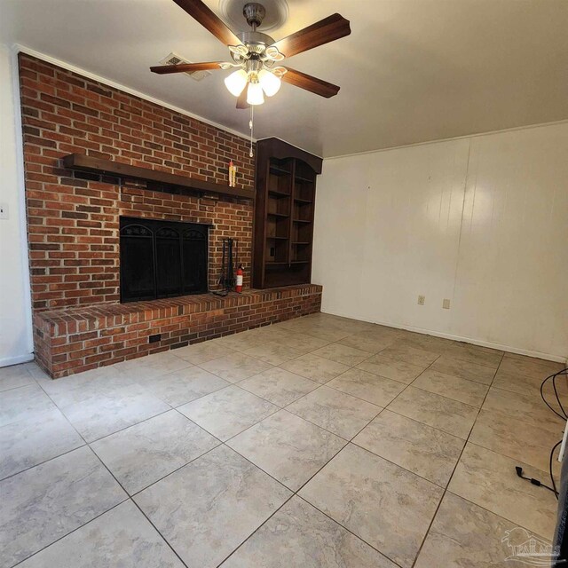 unfurnished living room featuring ceiling fan, a brick fireplace, and light tile patterned flooring