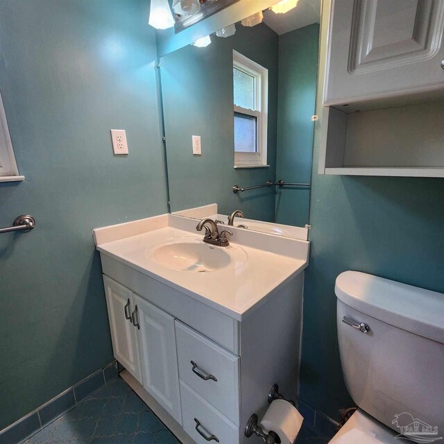 bathroom featuring tile patterned flooring, vanity, and toilet