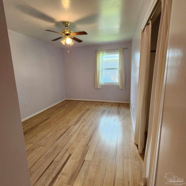 empty room featuring light hardwood / wood-style flooring and ceiling fan