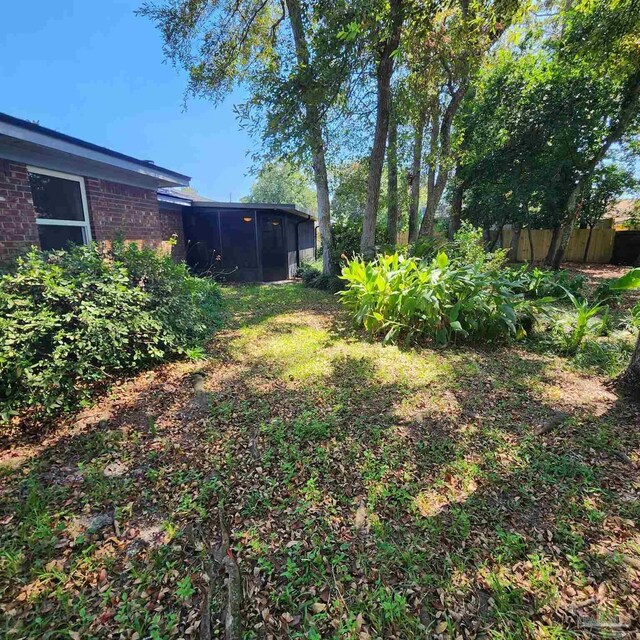 view of yard with a sunroom