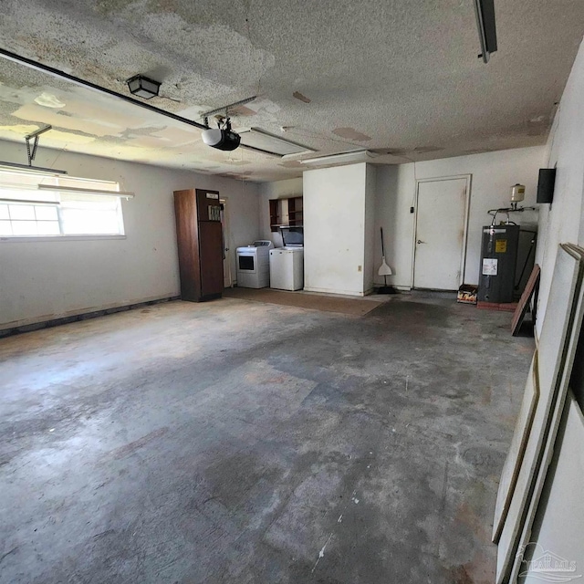 garage with separate washer and dryer, water heater, and a garage door opener