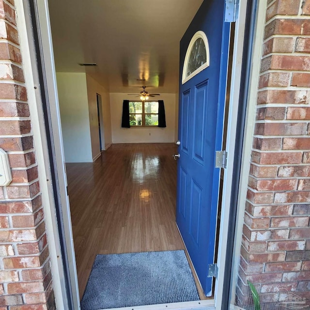 view of exterior entry featuring ceiling fan