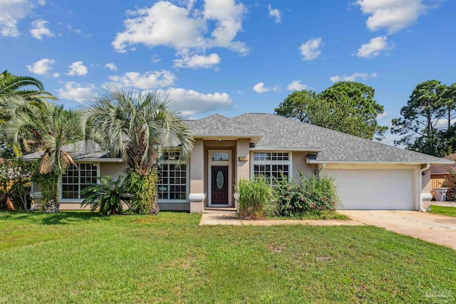 view of front of home with a garage and a front lawn