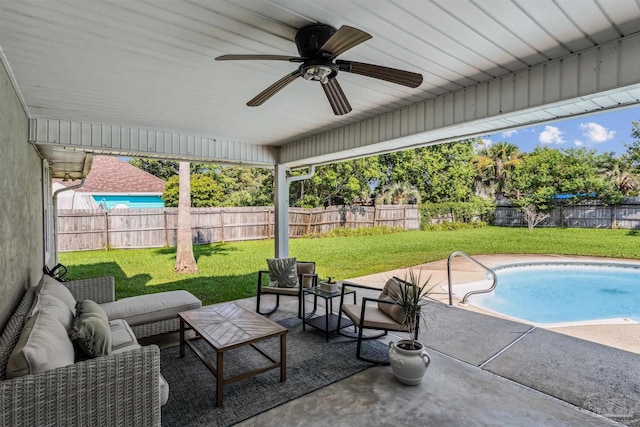 view of patio / terrace featuring ceiling fan, a fenced in pool, and an outdoor living space