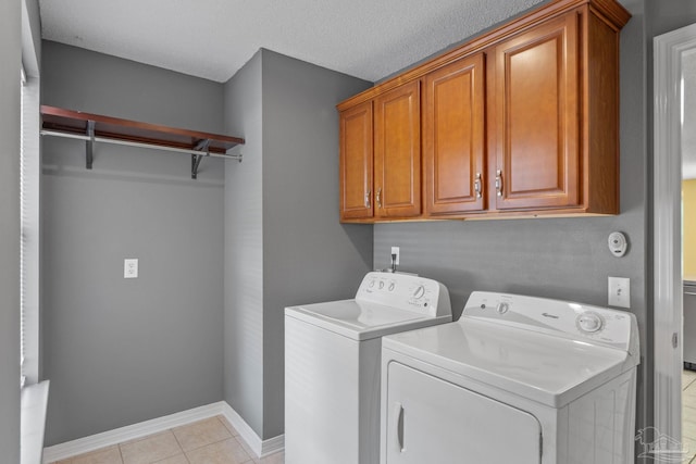 6299 Anderson Ln, Milton, FL 32570 - washroom with cabinet space, washing machine and dryer, and light tile patterned floors