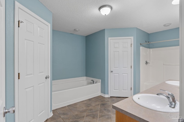 6299 Anderson Ln, Milton, FL 32570 - bathroom featuring a bath, double vanity, and a textured ceiling