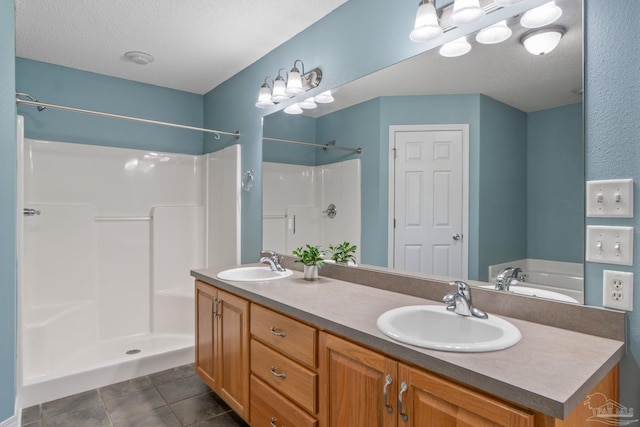 6299 Anderson Ln, Milton, FL 32570 - bathroom with double vanity, a shower, a textured ceiling, a tub to relax in, and tile patterned flooring
