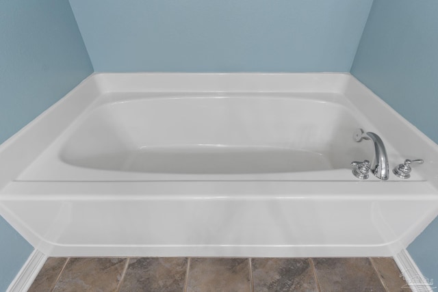 6299 Anderson Ln, Milton, FL 32570 - full bathroom with a bath and stone finish floors