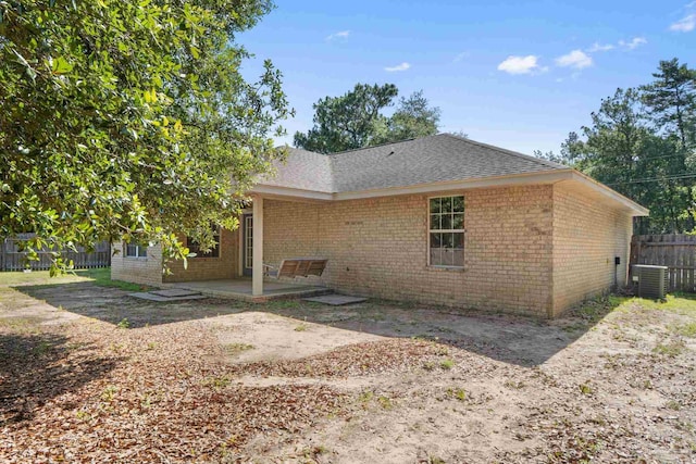6299 Anderson Ln, Milton, FL 32570 - back of property featuring brick siding, a patio area, and roof with shingles