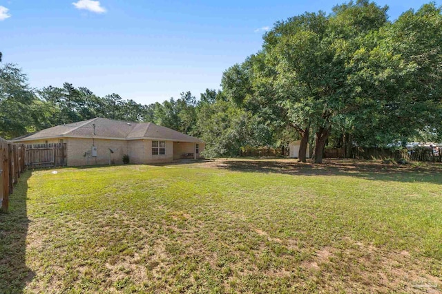 6299 Anderson Ln, Milton, FL 32570 - fenced backyard with a storage unit