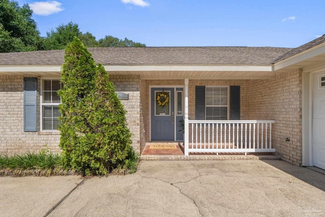 6299 Anderson Ln, Milton, FL 32570 - entrance to property with brick siding, a porch, and roof with shingles
