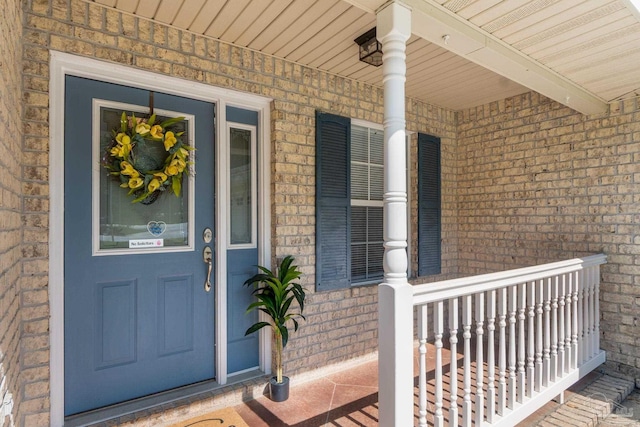 6299 Anderson Ln, Milton, FL 32570 - view of exterior entry featuring a porch and brick siding