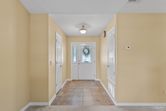 6299 Anderson Ln, Milton, FL 32570 - foyer with a textured ceiling and light tile patterned floors