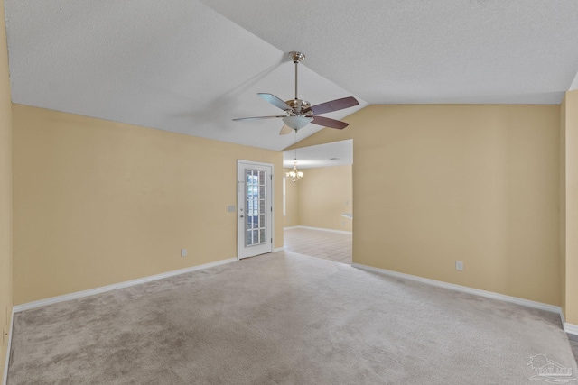 6299 Anderson Ln, Milton, FL 32570 - empty room featuring ceiling fan, carpet floors, vaulted ceiling, a chandelier, and a textured ceiling
