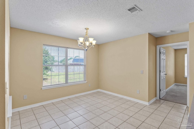 6299 Anderson Ln, Milton, FL 32570 - unfurnished room featuring a chandelier, a textured ceiling, a smoke detector, and light tile patterned floors