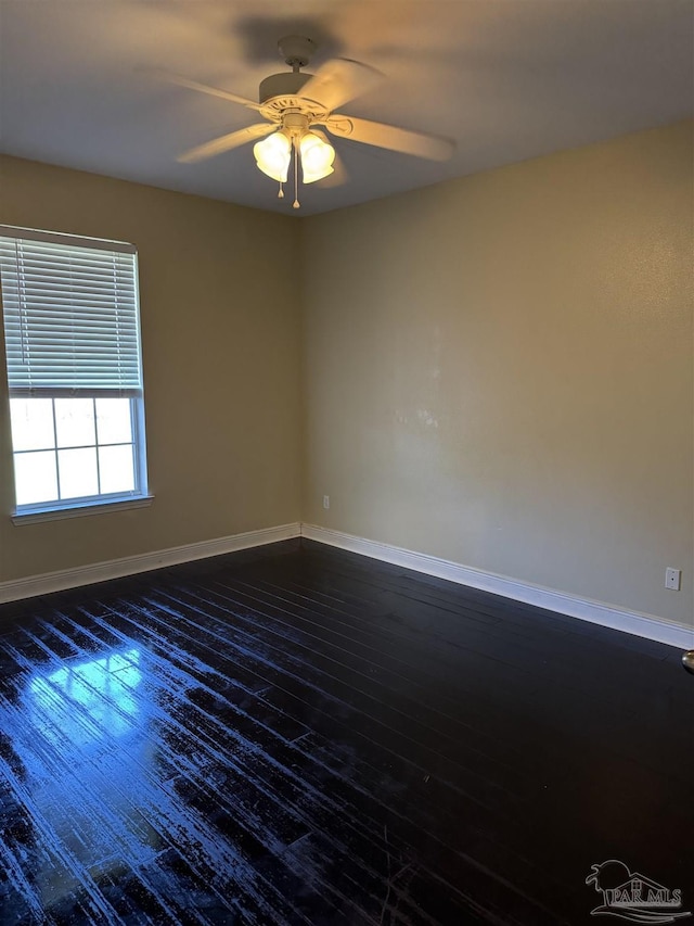 unfurnished room with dark wood-type flooring, baseboards, and ceiling fan