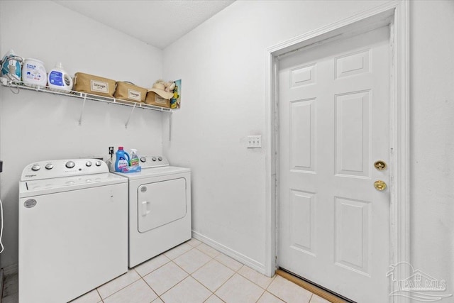 5761 Twisted Oak Ct, Pace, FL 32571 - washroom featuring baseboards, washing machine and dryer, laundry area, and light tile patterned floors