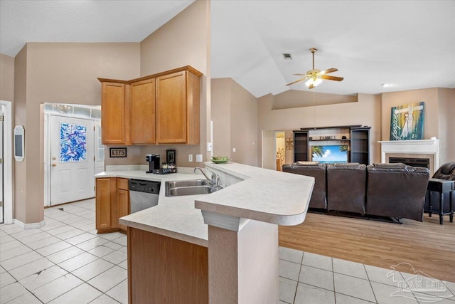 5761 Twisted Oak Ct, Pace, FL 32571 - kitchen with a sink, a peninsula, ceiling fan, light countertops, and light tile patterned floors