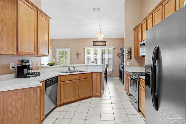 5761 Twisted Oak Ct, Pace, FL 32571 - kitchen with stainless steel appliances, light tile patterned floors, a sink, a peninsula, and light countertops