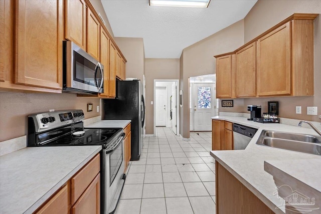 5761 Twisted Oak Ct, Pace, FL 32571 - kitchen with a sink, stainless steel appliances, a textured ceiling, and light countertops