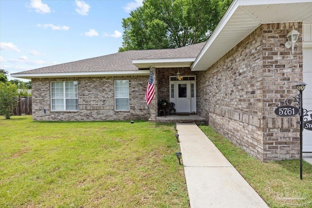 5761 Twisted Oak Ct, Pace, FL 32571 - view of front of house featuring roof with shingles, fence, a front lawn, and brick siding